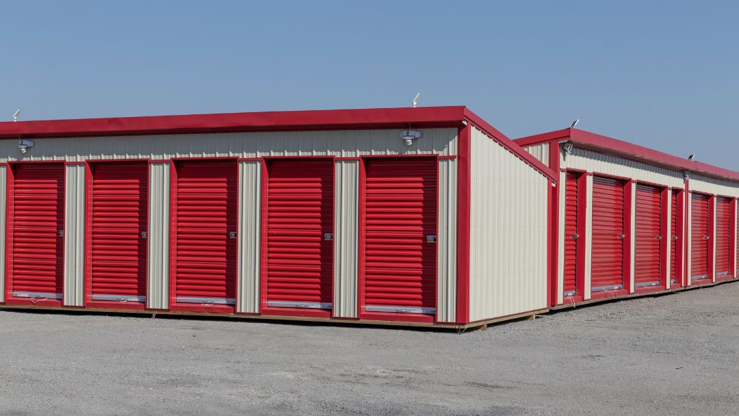 outside view of rows of self storage units with red garage doors