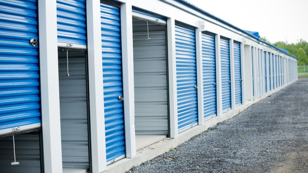outside view of storage units with open blue garage doors